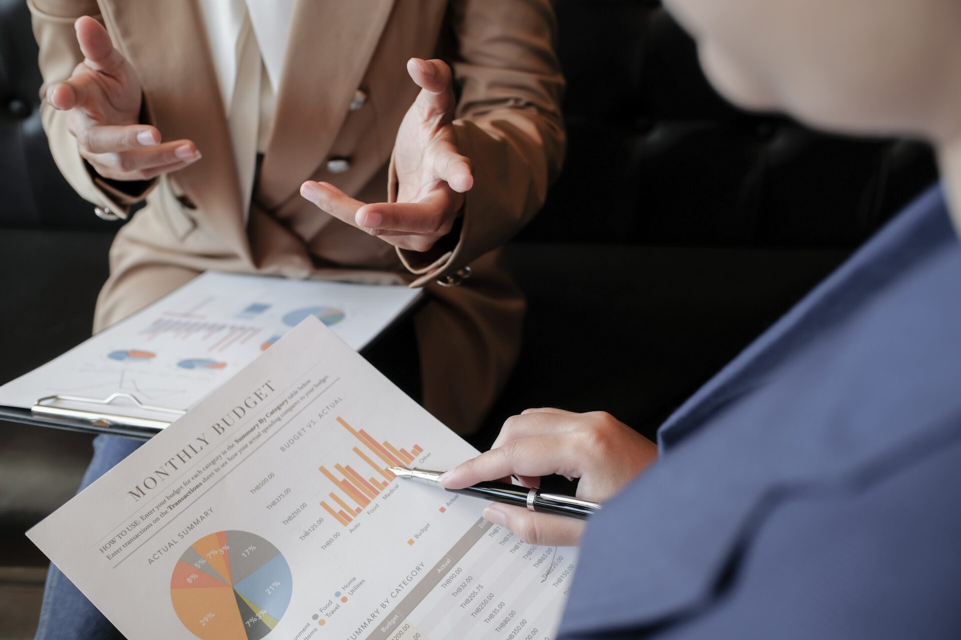 Young pregnant woman, reading book at home to her boys