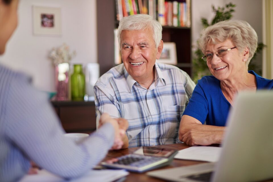 Senior Couple shaking hands with the accountant.